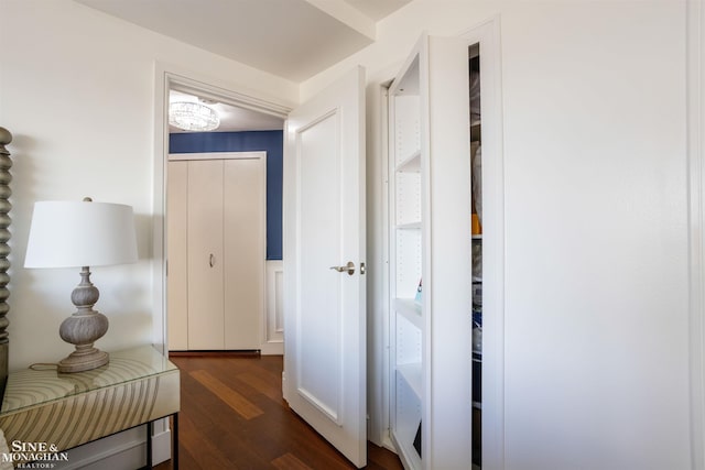 corridor featuring dark wood-style flooring