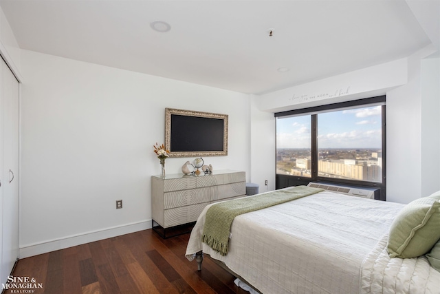 bedroom with baseboards and wood finished floors