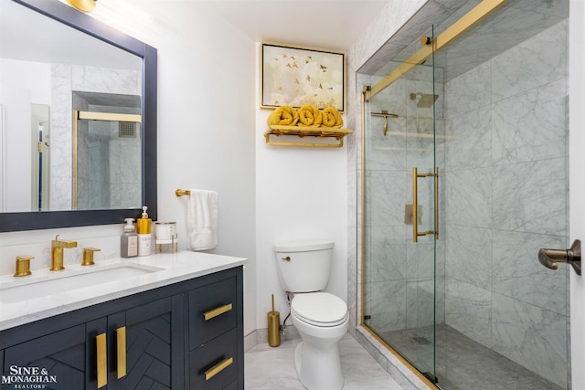 bathroom featuring toilet, a stall shower, and vanity