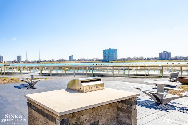 exterior space with a view of city, a water view, and area for grilling