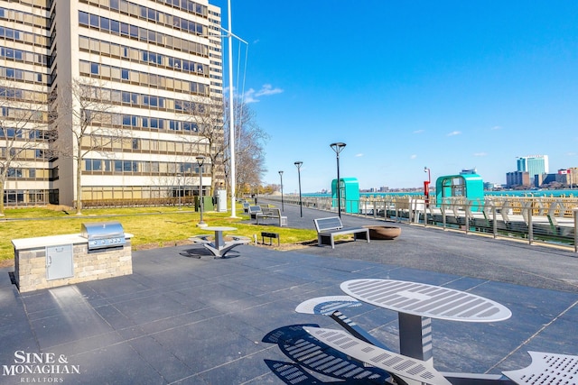 surrounding community featuring a city view, exterior kitchen, and a yard