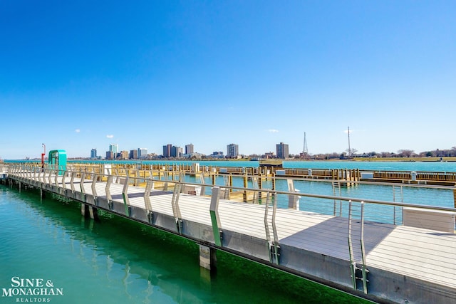 dock area featuring a pier, a view of city, and a water view