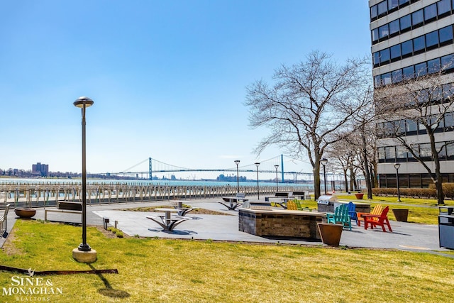 view of home's community featuring a water view and a yard