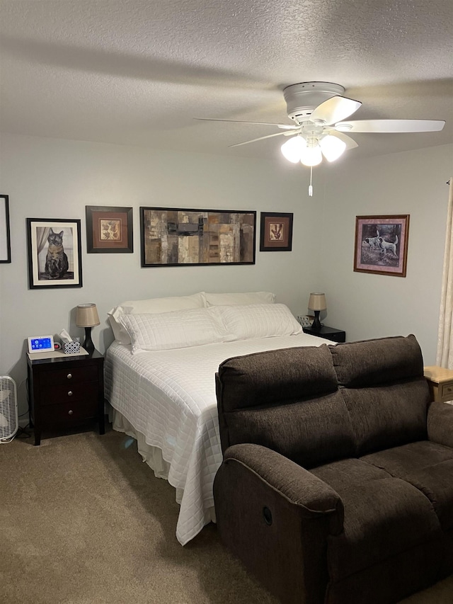 bedroom featuring a ceiling fan, carpet flooring, and a textured ceiling