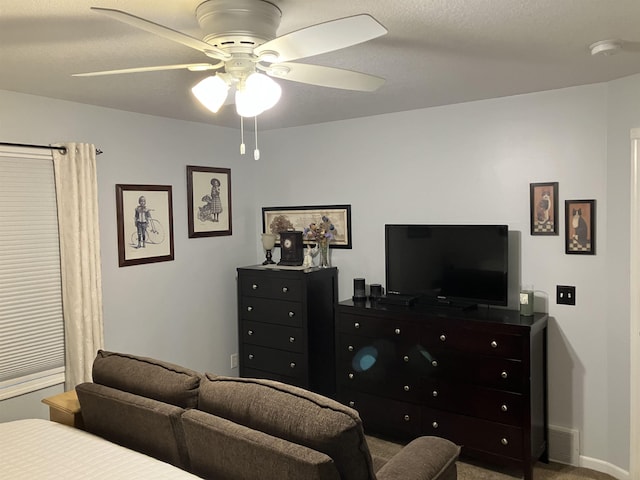 bedroom with a ceiling fan, carpet flooring, a textured ceiling, and baseboards