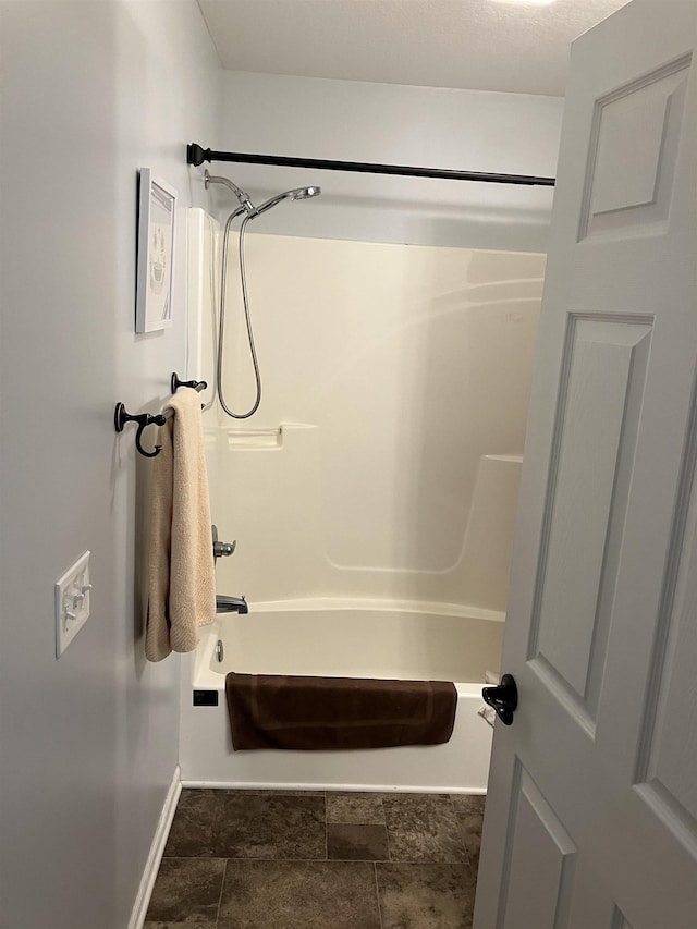 full bathroom featuring bathing tub / shower combination and baseboards