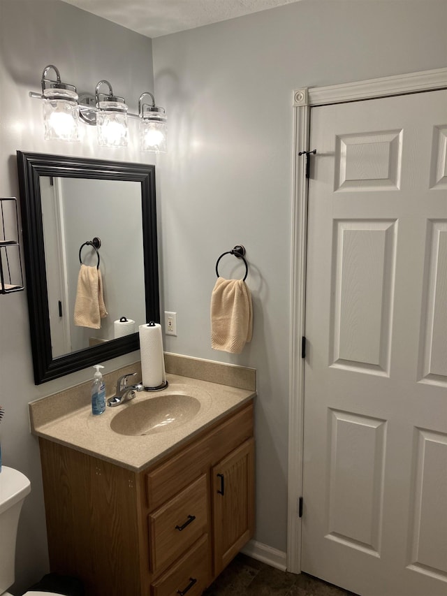 bathroom featuring toilet and vanity