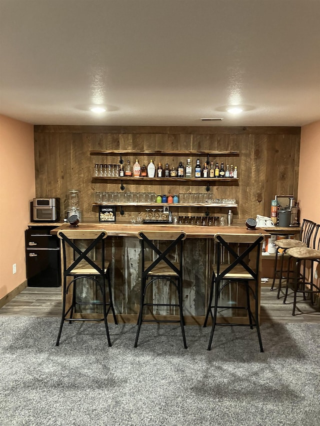 bar with wood walls and a bar