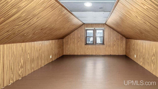 additional living space featuring lofted ceiling, wood ceiling, dark wood finished floors, and wood walls