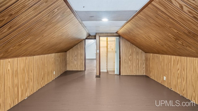 bonus room with lofted ceiling, dark wood-style floors, wood ceiling, and wooden walls