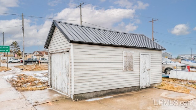 view of outdoor structure with an outbuilding and fence