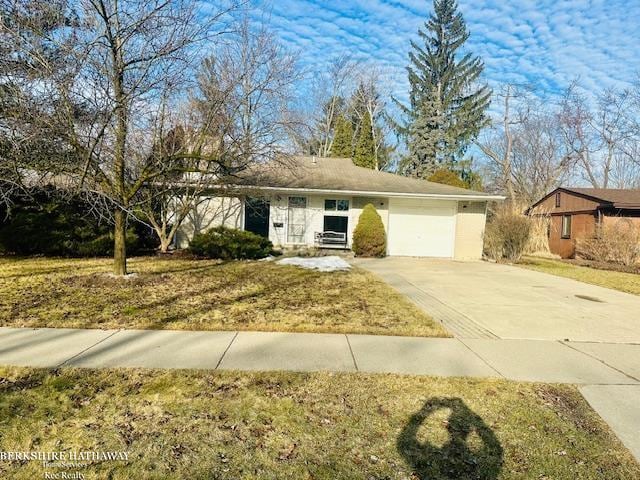 ranch-style home with driveway, a front lawn, and an attached garage