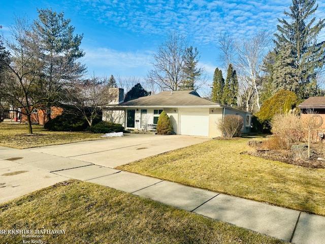 single story home with driveway, a front lawn, a chimney, and an attached garage