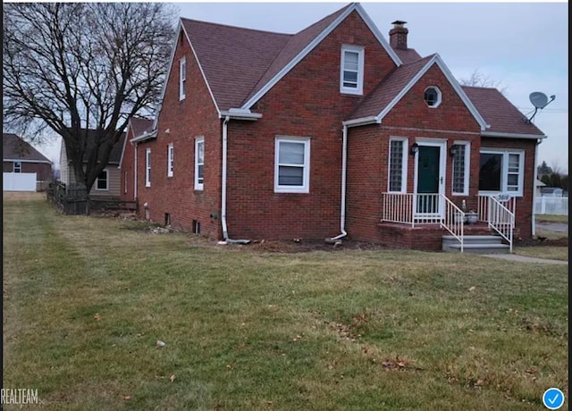 bungalow-style home with brick siding, a chimney, and a front lawn