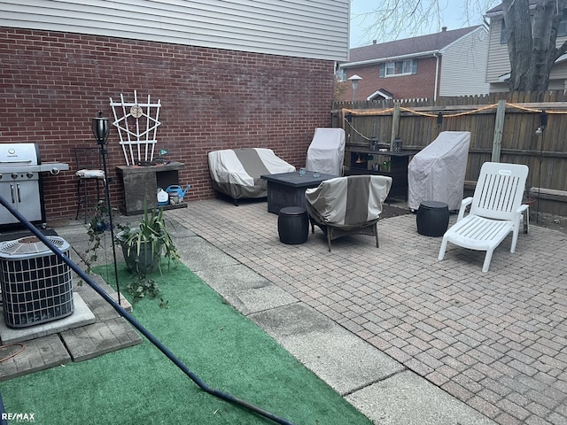 view of patio / terrace featuring grilling area, fence, and cooling unit