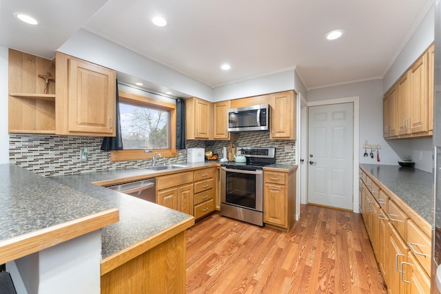 kitchen featuring appliances with stainless steel finishes, a kitchen breakfast bar, a peninsula, crown molding, and light wood-type flooring