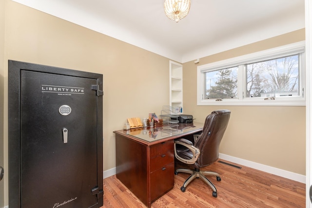 office area featuring light wood finished floors and baseboards