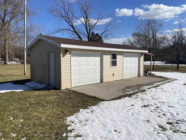 snow covered garage with a garage