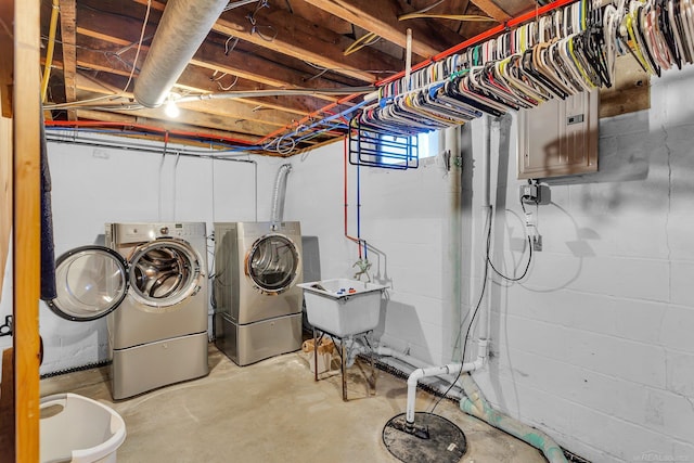 laundry area with laundry area, separate washer and dryer, and a sink