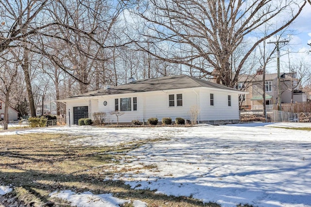 single story home featuring a garage and fence