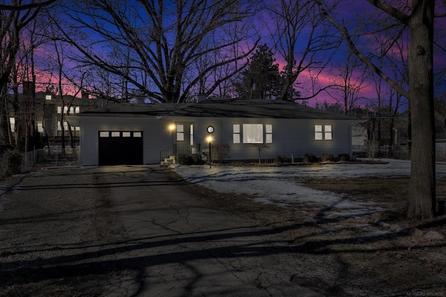 view of front of home with a garage and aphalt driveway