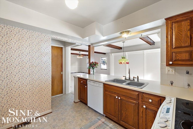 kitchen with light countertops, brown cabinetry, a sink, range, and dishwasher