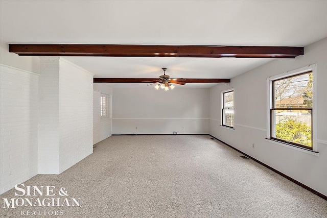 unfurnished room with baseboards, visible vents, light colored carpet, ceiling fan, and beam ceiling