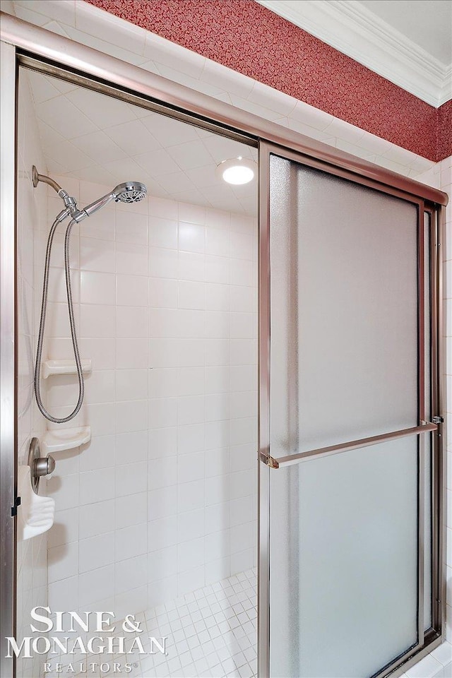 bathroom featuring a stall shower and crown molding