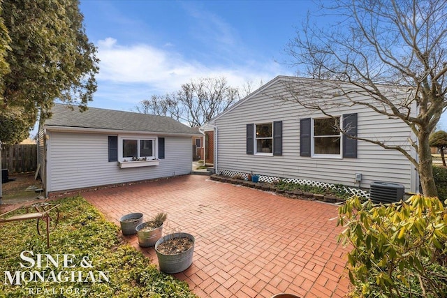 view of side of property with cooling unit, a patio area, and fence