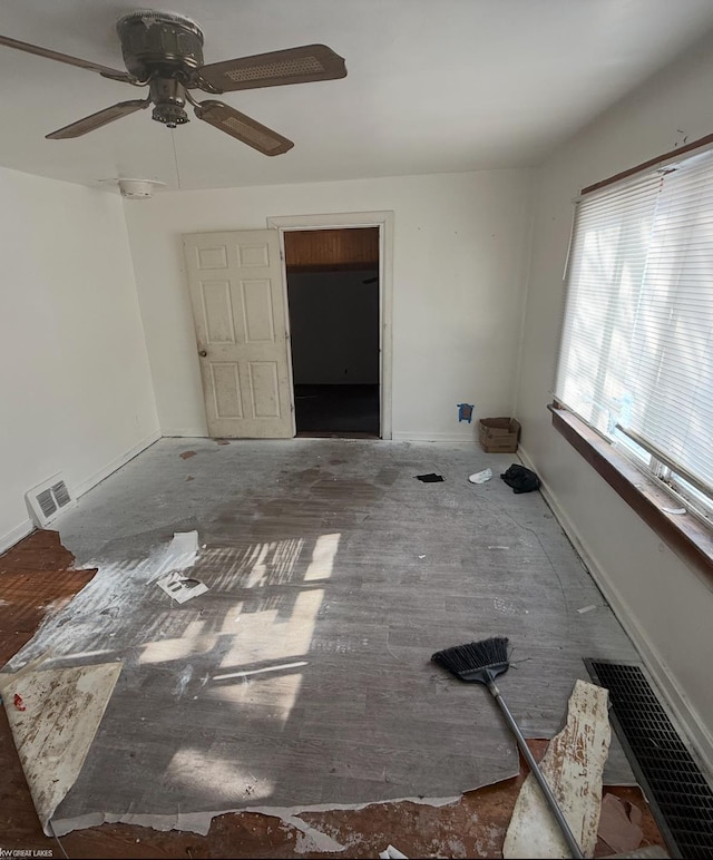 unfurnished room featuring visible vents and baseboards