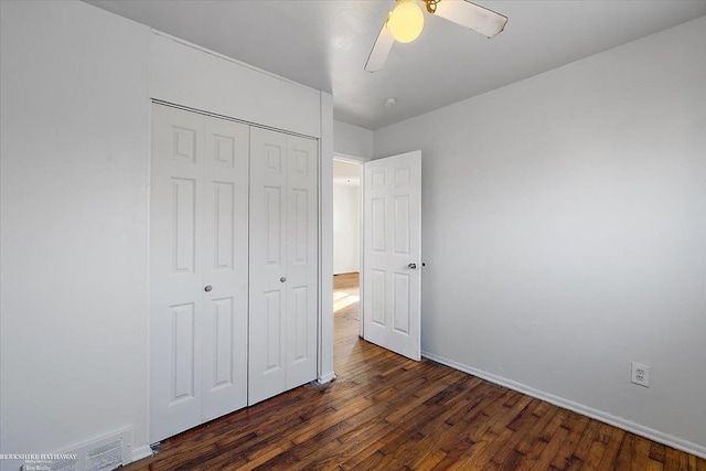 unfurnished bedroom with baseboards, a closet, a ceiling fan, and wood finished floors