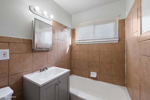 full bath featuring bathtub / shower combination, toilet, tile walls, and vanity