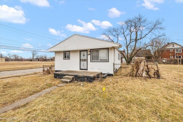 bungalow-style house with fence and a front yard