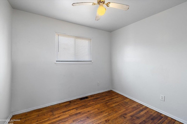 empty room featuring ceiling fan, baseboards, and wood finished floors