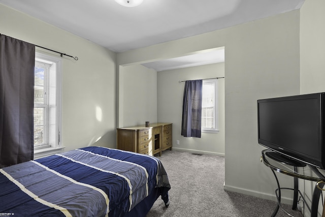 bedroom with carpet floors and baseboards