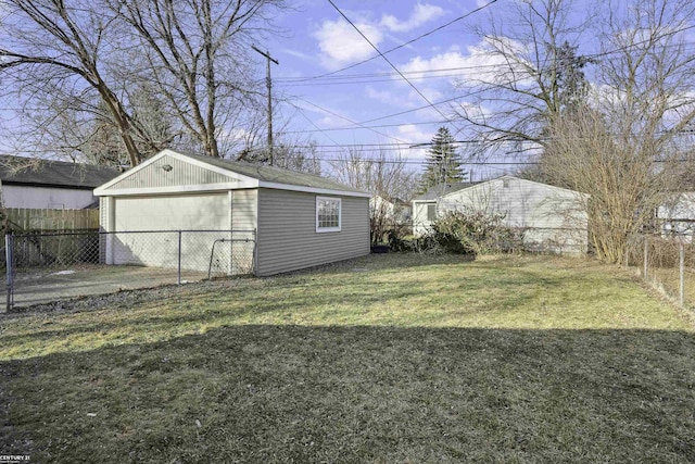 view of yard with a garage, fence, and an outdoor structure