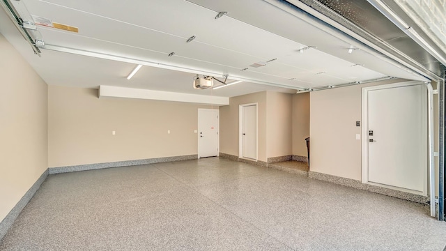 garage featuring baseboards and a garage door opener