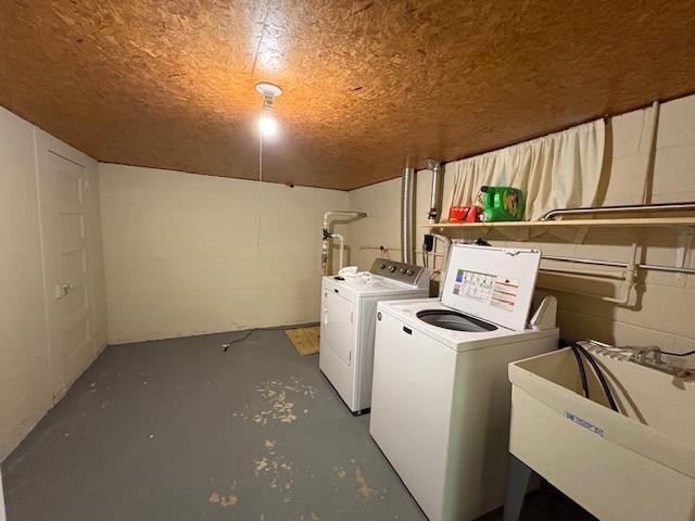 laundry area with a sink and washer and clothes dryer