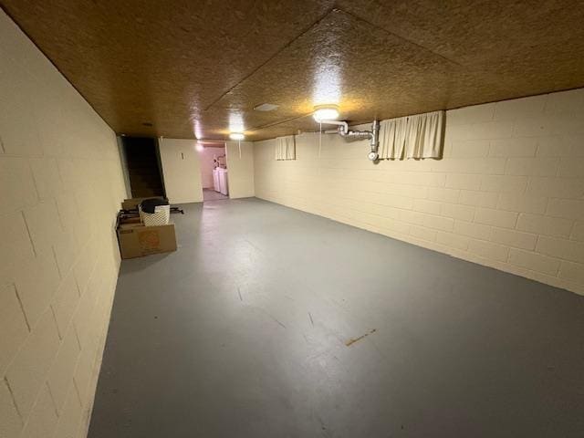 finished basement featuring concrete block wall