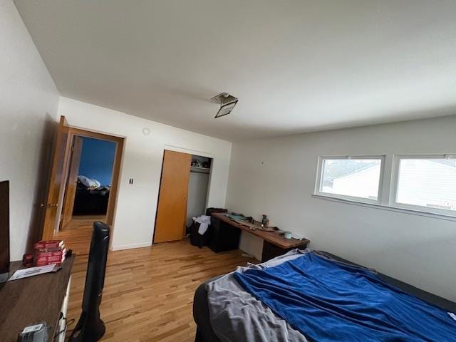 bedroom featuring a closet and light wood finished floors