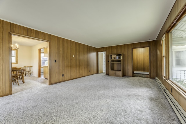 empty room with a baseboard radiator, light carpet, plenty of natural light, and baseboard heating