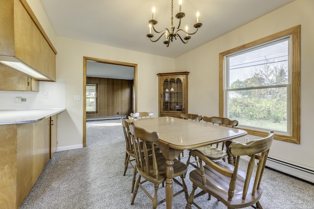 dining room featuring light carpet, an inviting chandelier, baseboards, and a baseboard heating unit