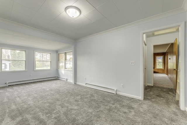 unfurnished room featuring carpet floors, baseboard heating, and crown molding