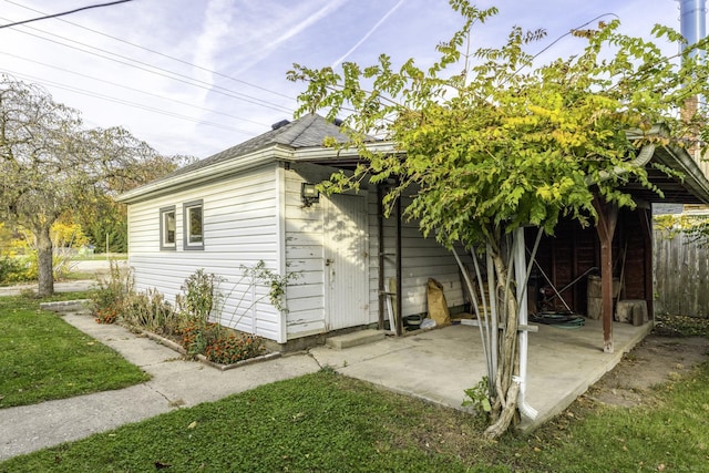 view of side of home with a patio area and fence