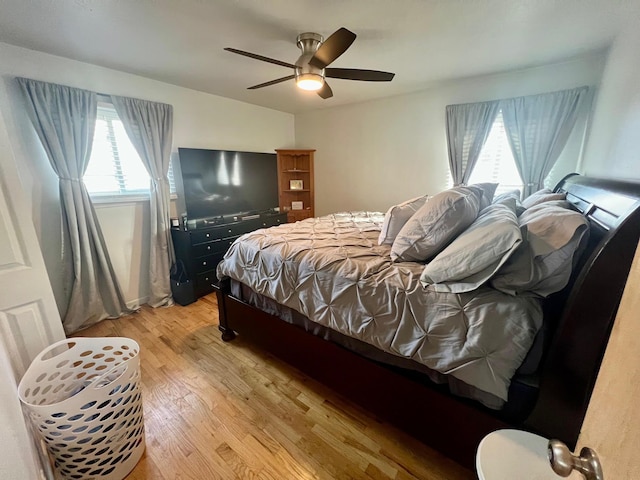 bedroom with light wood-style floors and ceiling fan