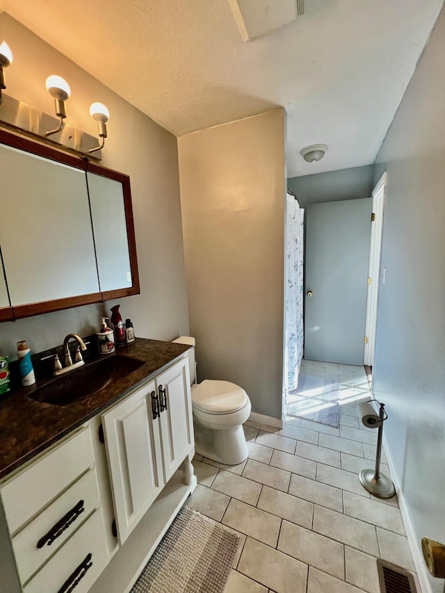 bathroom with visible vents, baseboards, toilet, tile patterned flooring, and vanity