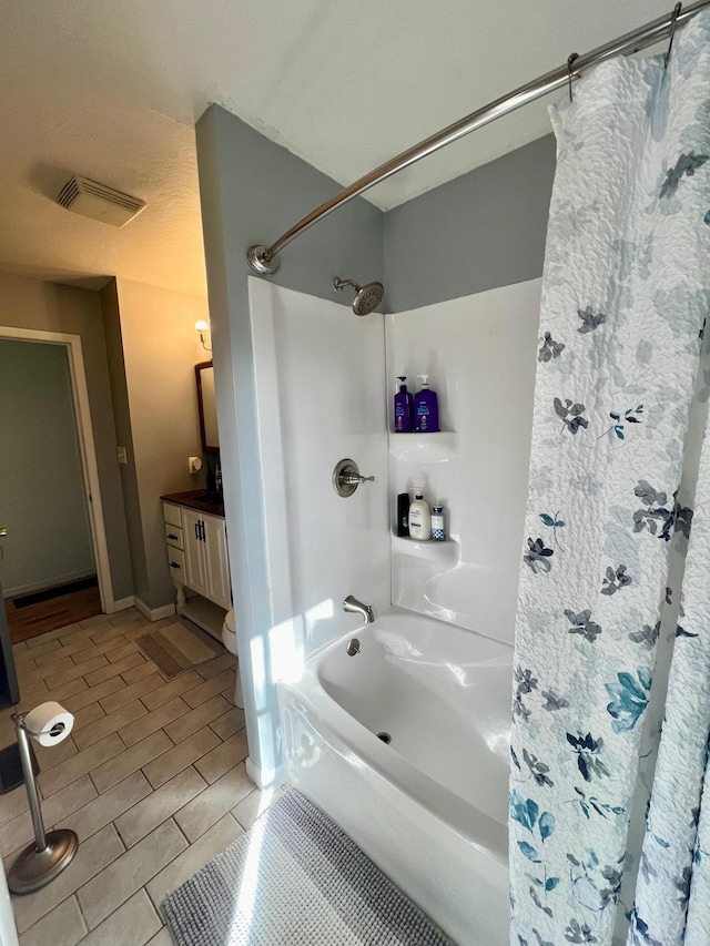 bathroom with wood tiled floor, visible vents, shower / tub combo with curtain, and vanity