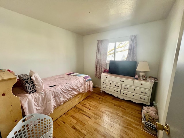 bedroom with light wood finished floors