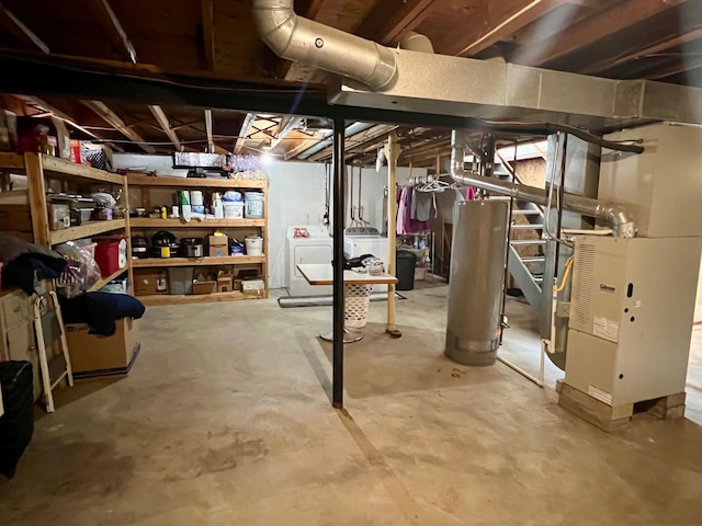 unfinished basement featuring washer and dryer, water heater, and heating unit