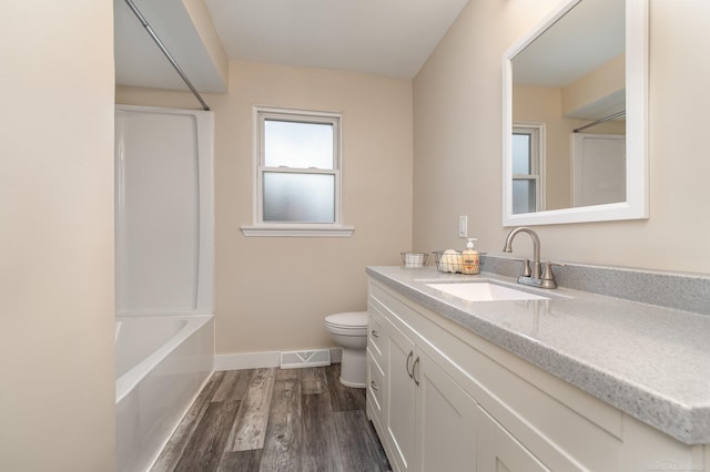 full bath featuring baseboards, visible vents, toilet, wood finished floors, and vanity